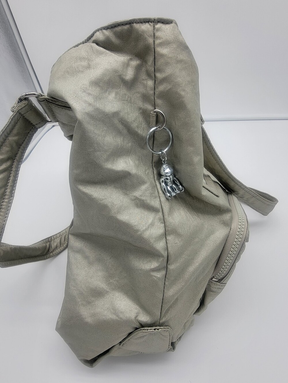 Kipling Metallic Light Gray Crossbody Backpack with Silver Keychain